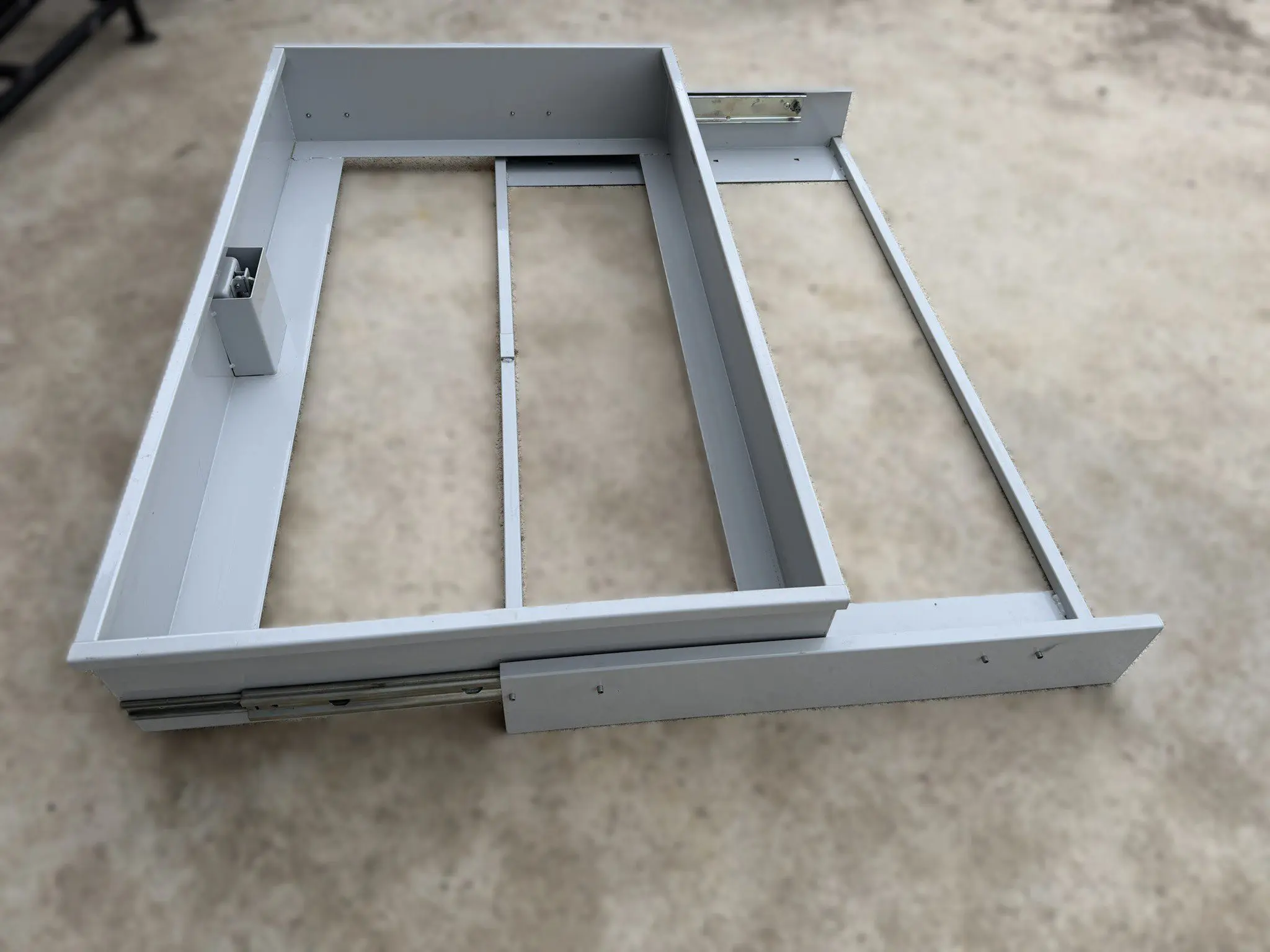 Pull out metal drawer under counter storage configuration for shop or trailer cabinet