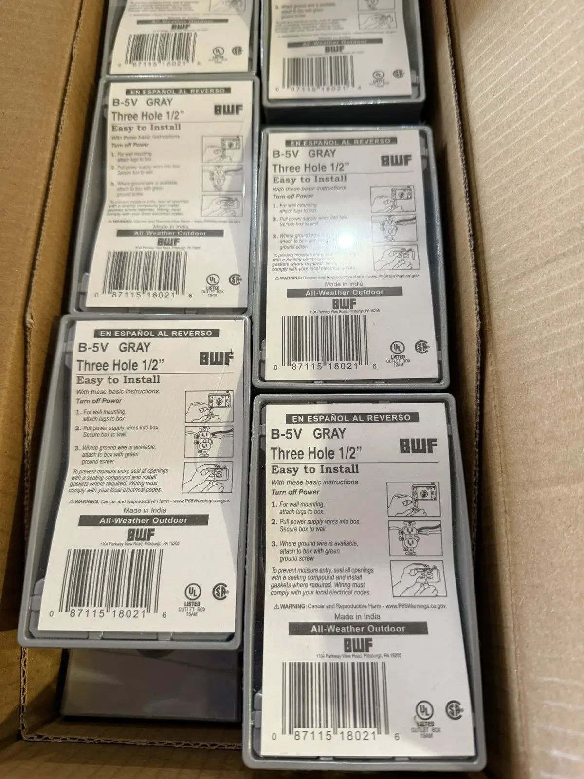 Carton of new BWF B-5V gray three hole 1/2 inch weatherproof boxes in shrink wrap with install cards
