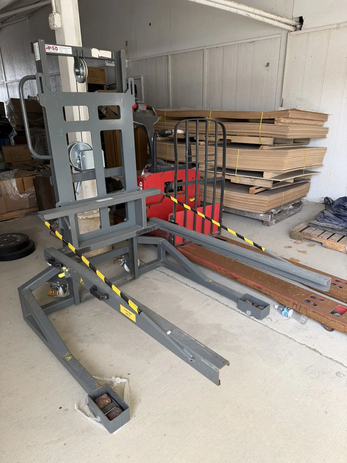 Side view of KNAPP OSR manual stacker showing forks, winch, and casters